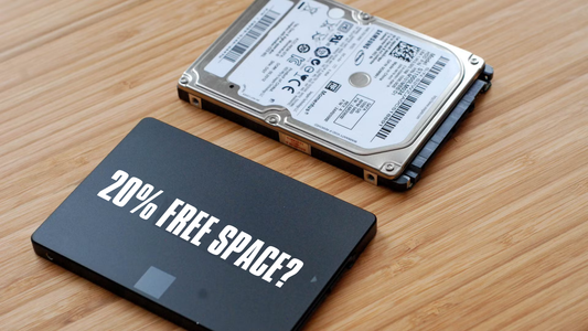 2.5-inch SATA SSD and laptop HDD side by side on a wooden desk with text asking 20% Free Space? — drive storage management guide