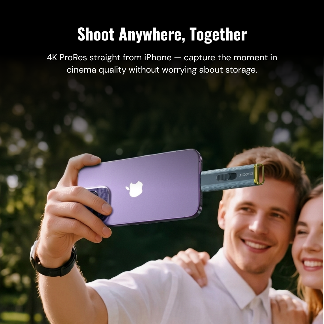 Person holding a smartphone with a camera attachment, outdoors.